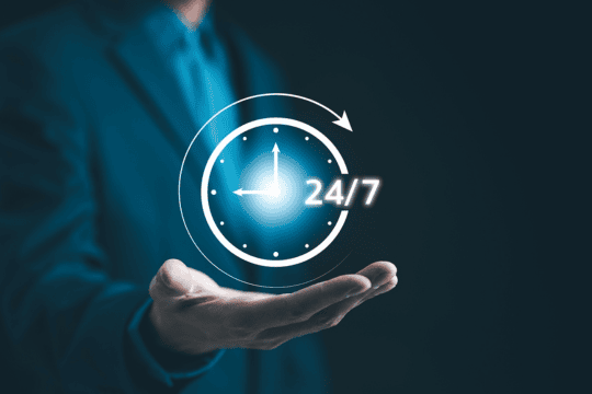 A logo of a clock showing 24/7 is hovering over an open hand.